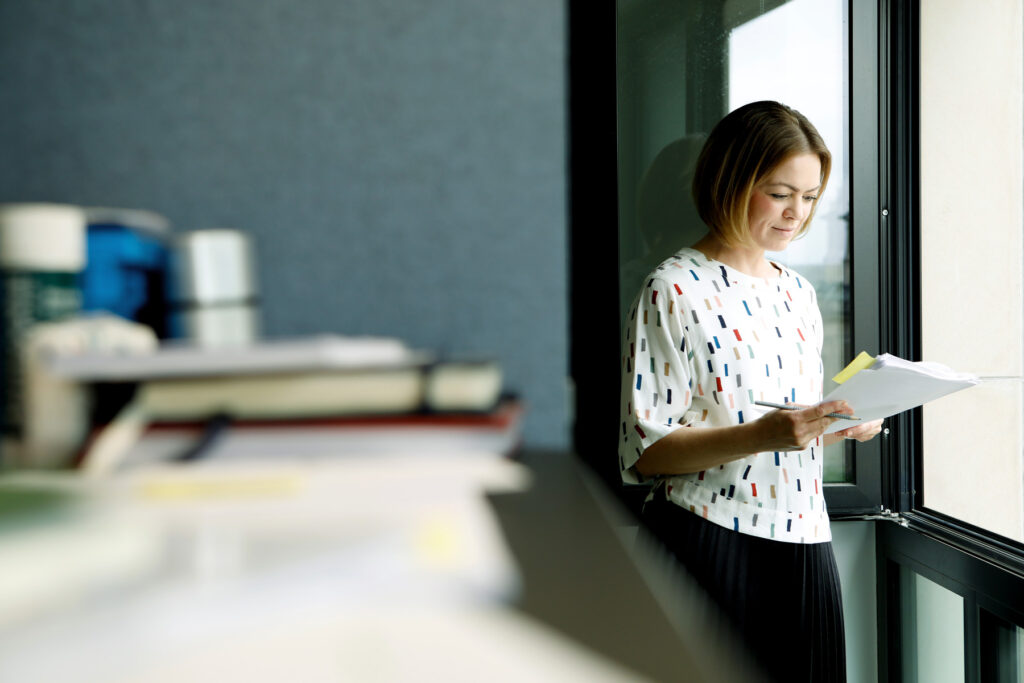 Lisa Lux, E3 Holding SE, steht am Fenster
